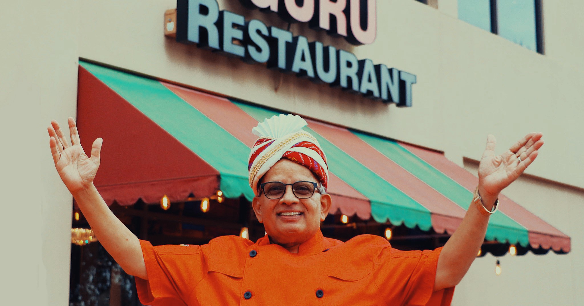 Guru Restaurant's Chef and Owner Uday Kadam posing in front of Guru Restaurant